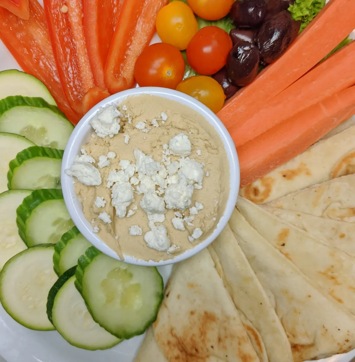 House-made hummus with vegetables and pita
