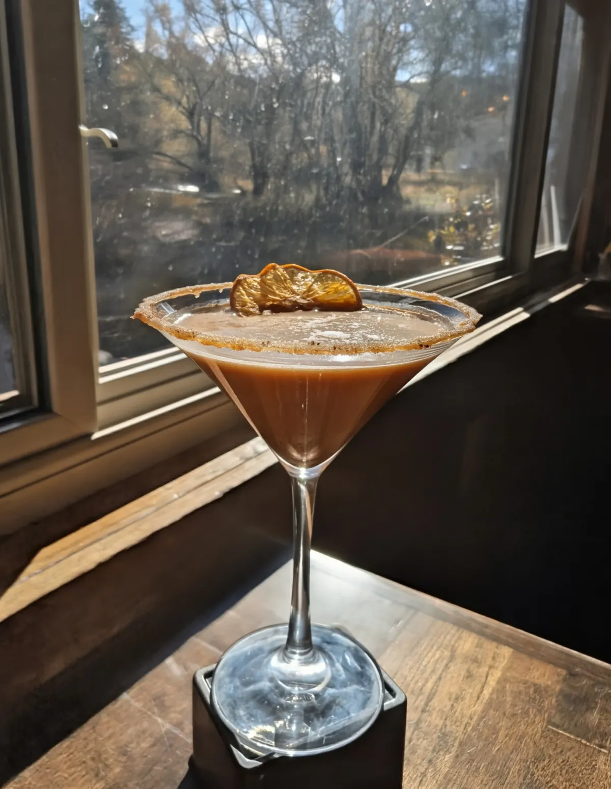 Seasonal cocktail overlooking Bear Creek