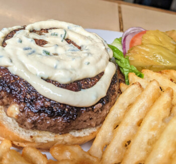 Cheeseburger with grilled onion and waffle fries