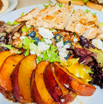 Grilled chicken salad with greens, feta, and sliced peaches