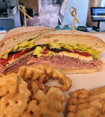 Layered club sandwich with breakfast potatoes