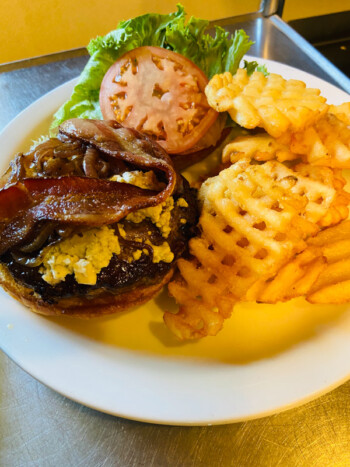 Burger with waffle fries and dipping sauce
