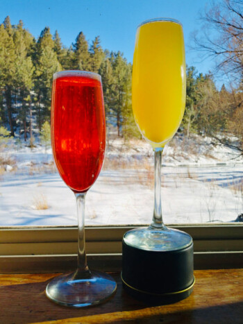 Two colorful cocktails overlooking snowy Bear Creek