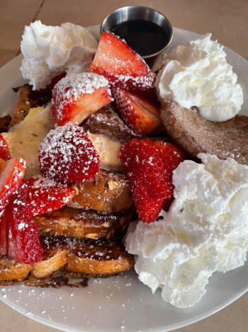 French toast topped with strawberries and whipped cream